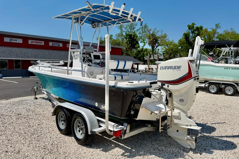 Slide: The Image of 2001 Sea Fox 215 Bay Fisher boat with Evinrude engine on a trailer in a dealership lot. - 7