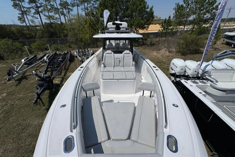 Slide: The Image of 2019 Everglades 435 Center Console boat with spacious seating, docked outdoors. - 15