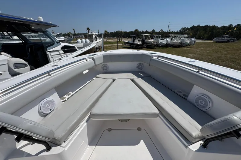 Slide: The Image of 2019 Everglades 435 Center Console boat interior with cushioned seating and speakers. - 18