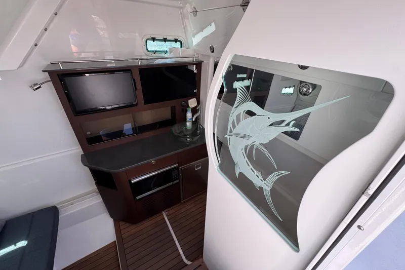 Slide: The Image of Interior of 2019 Everglades 435 Center Console with etched marlin glass and modern amenities. - 22