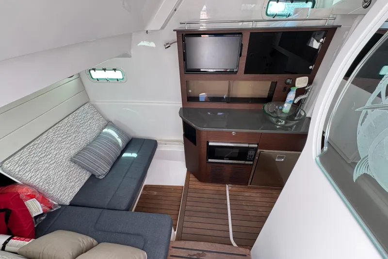 Slide: The Image of Interior of 2019 Everglades 435 Center Console with seating, kitchenette, and entertainment area. - 23
