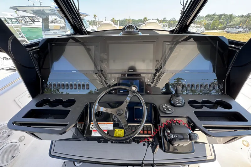 Slide: The Image of Control panel of a 2019 Everglades 435 Center Console boat with advanced navigation displays. - 34