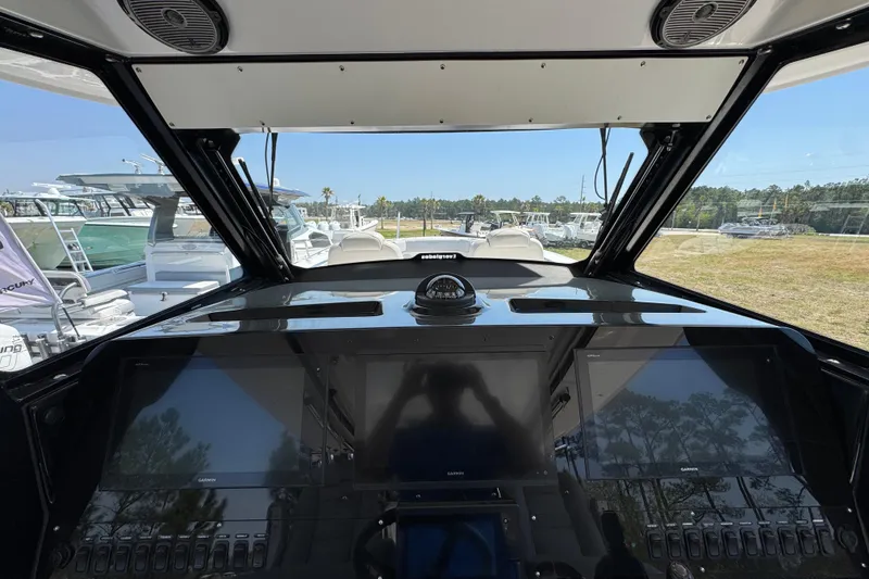 Slide: The Image of 2019 Everglades 435 Center Console helm with advanced navigation displays and controls. - 35