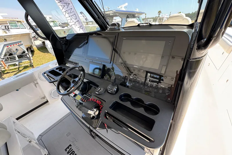 Slide: The Image of 2019 Everglades 435 Center Console boat dashboard with advanced navigation and control systems. - 37