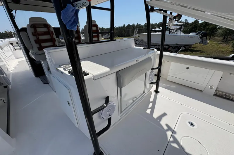 Slide: The Image of 2019 Everglades 435 Center Console boat interior with seating and storage compartments. - 38