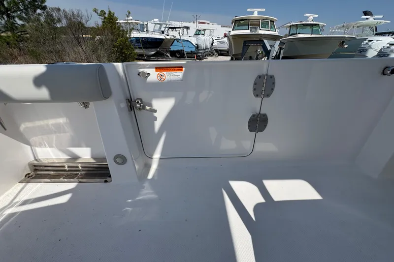 Slide: The Image of 2019 Everglades 435 Center Console boat interior with open deck and visible hinges. - 43