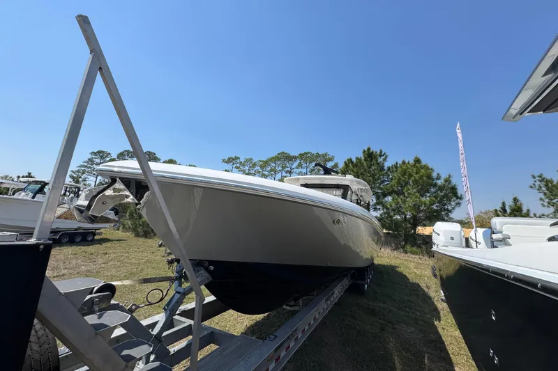Slide: The Image of 2019 Everglades 435 Center Console boat on trailer, displayed outdoors under clear blue sky. - 5