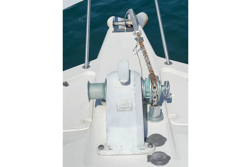 Slide: The Image of Anchor winch on 1996 Riviera 4800 Sport Yacht deck, with chain and railing. - 100