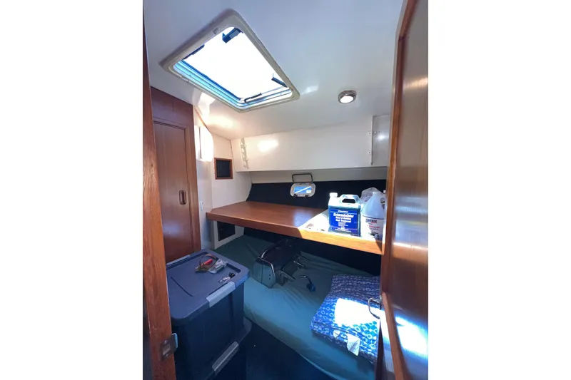 Slide: The Image of Interior cabin of 1996 Riviera 4800 Sport Yacht with storage and bedding. - 21