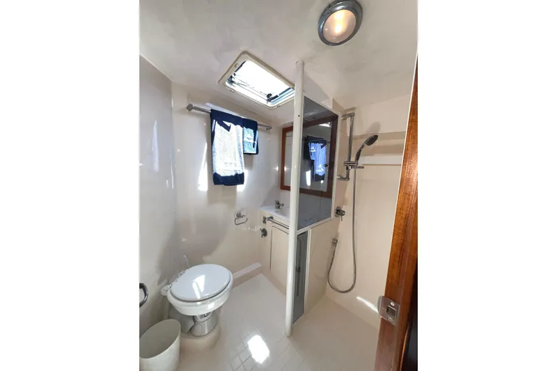 Slide: The Image of Bathroom interior of 1996 Riviera 4800 Sport Yacht with shower and skylight. - 23