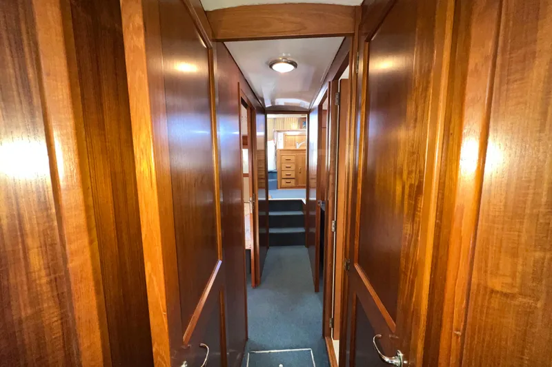 Slide: The Image of Interior hallway of 1996 Riviera 4800 Sport Yacht with wooden paneling and carpeted floor. - 24