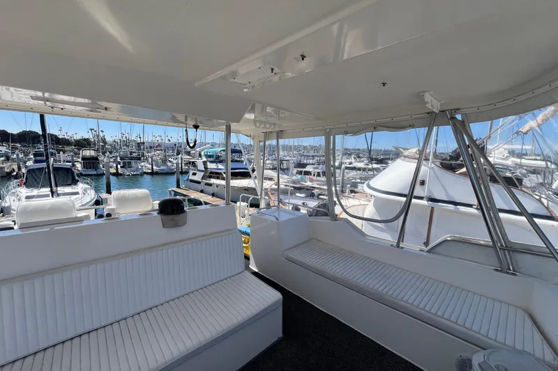 Slide: The Image of Interior view of a 1996 Riviera 4800 Sport Yacht docked at a marina. - 30