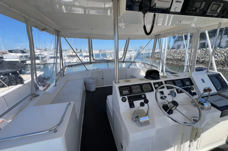 Slide: The Image of Interior view of 1996 Riviera 4800 Sport Yacht cockpit with steering wheel and navigation instruments. - 31
