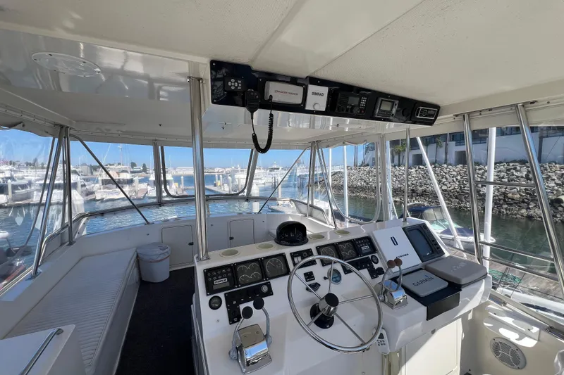 Slide: The Image of Interior view of 1996 Riviera 4800 Sport Yacht cockpit with navigation equipment and marina backdrop. - 32