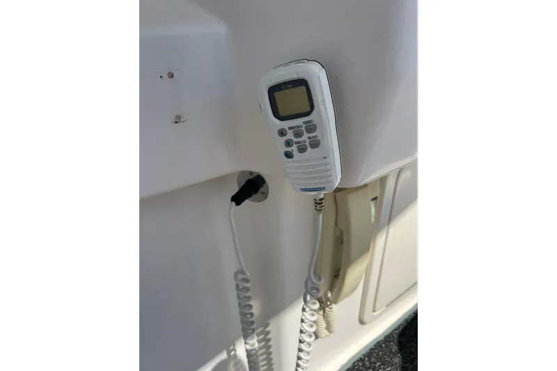Slide: The Image of VHF radio handset on 1996 Riviera 4800 Sport Yacht, mounted on white panel. - 35