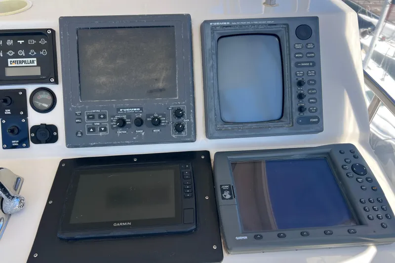 Slide: The Image of Control panel of a 1996 Riviera 4800 Sport Yacht with navigation and monitoring systems. - 36