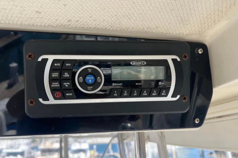 Slide: The Image of Jensen stereo system on 1996 Riviera 4800 Sport Yacht dashboard. - 37