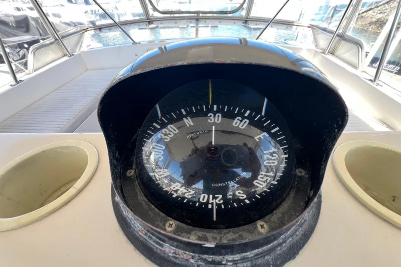 Slide: The Image of Compass on 1996 Riviera 4800 Sport Yacht, showcasing navigation equipment on deck. - 41