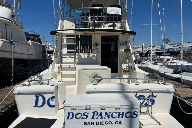 Slide: The Image of 1996 Riviera 4800 Sport Yacht docked in San Diego marina, named "Dos Panchos". - 44