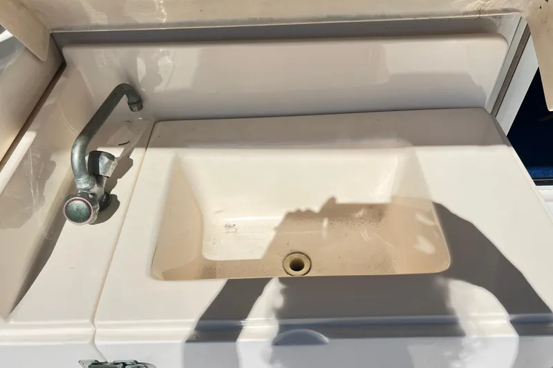 Slide: The Image of Sink and faucet on 1996 Riviera 4800 Sport Yacht, featuring a compact design. - 46
