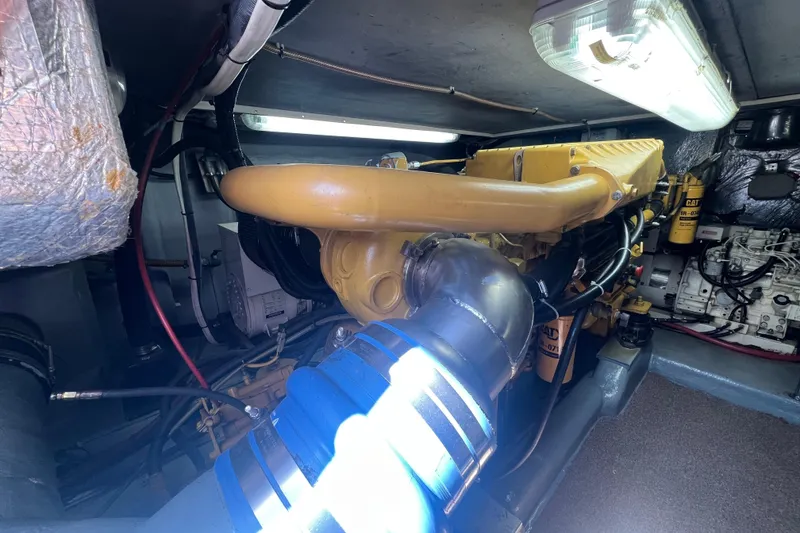 Slide: The Image of Engine room of a 1996 Riviera 4800 Sport Yacht with visible machinery and components. - 48