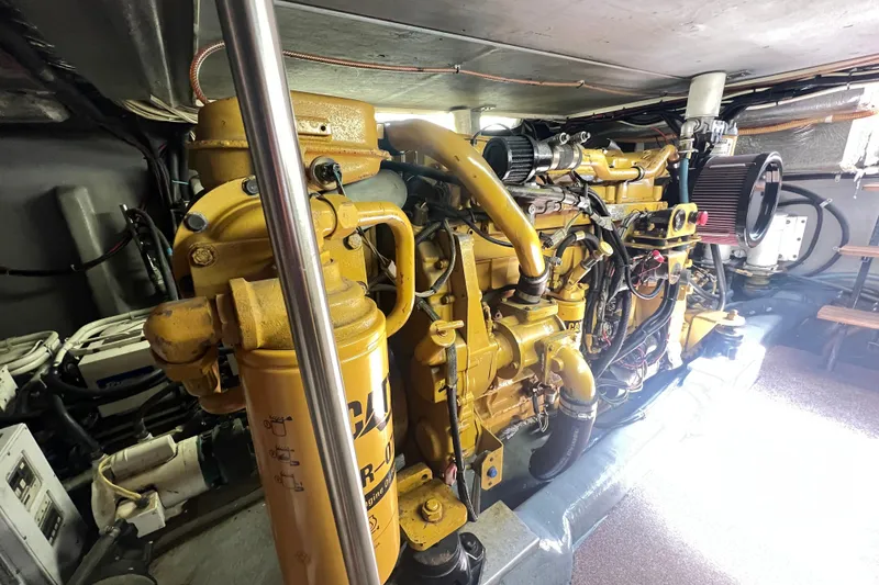 Slide: The Image of Engine room of a 1996 Riviera 4800 Sport Yacht, showcasing a powerful marine engine. - 49