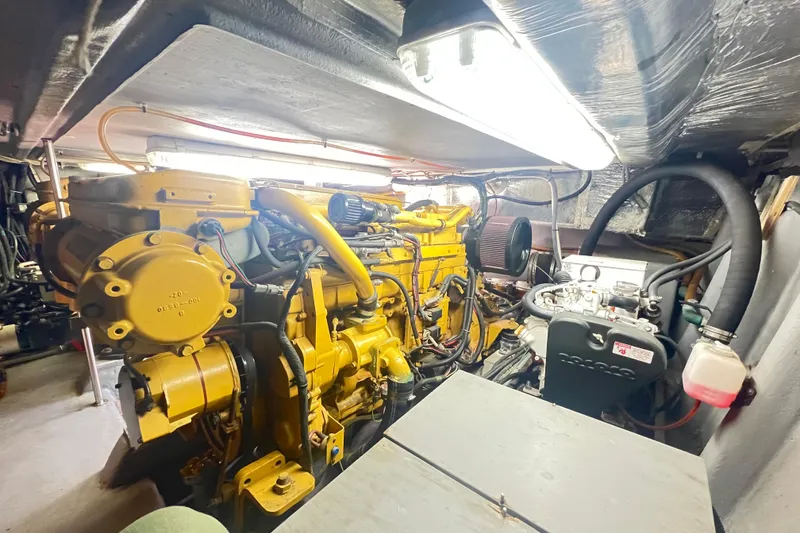 Slide: The Image of Engine room of a 1996 Riviera 4800 Sport Yacht, showcasing machinery and components. - 55