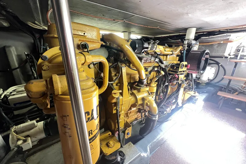 Slide: The Image of Engine room of a 1996 Riviera 4800 Sport Yacht, showcasing a powerful marine engine. - 56