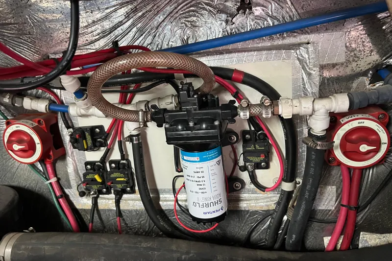 Slide: The Image of Electrical and plumbing system in a 1996 Riviera 4800 Sport Yacht engine room. - 57