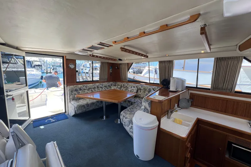 Slide: The Image of Interior of a 1996 Riviera 4800 Sport Yacht with dining area and kitchenette. - 6