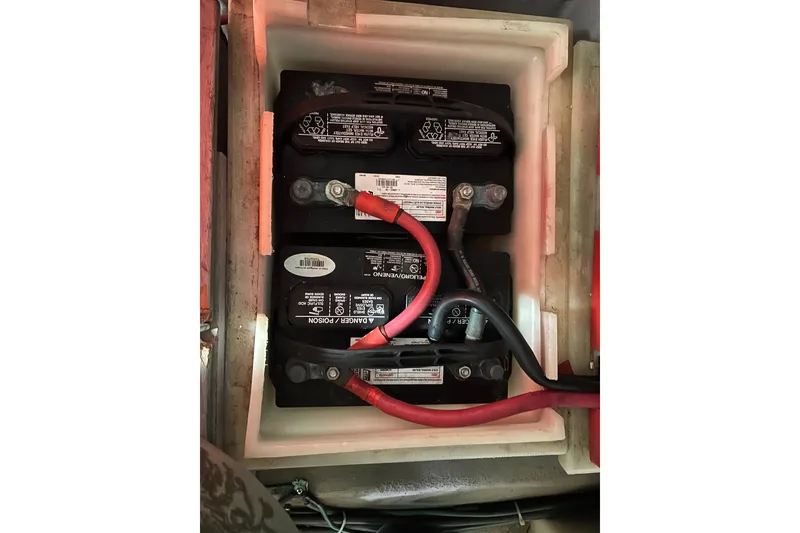 Slide: The Image of Battery compartment of a 1996 Riviera 4800 Sport Yacht with connected cables. - 63
