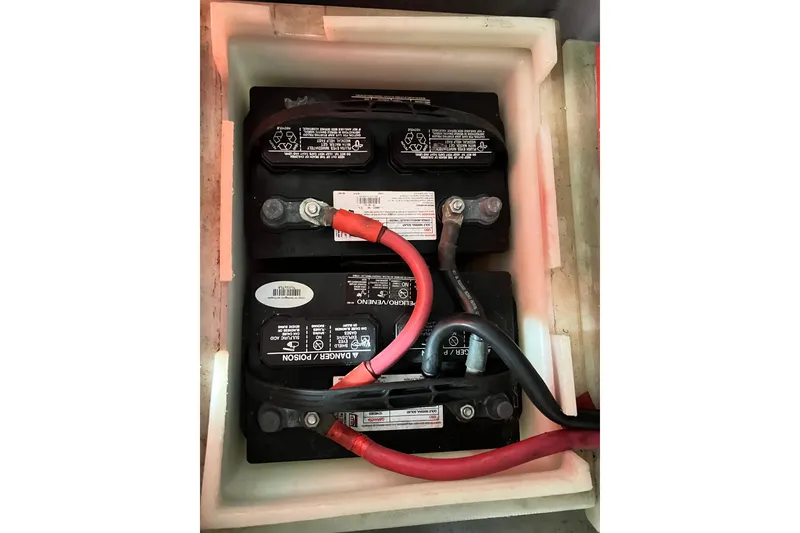Slide: The Image of Battery compartment of a 1996 Riviera 4800 Sport Yacht with connected cables. - 64