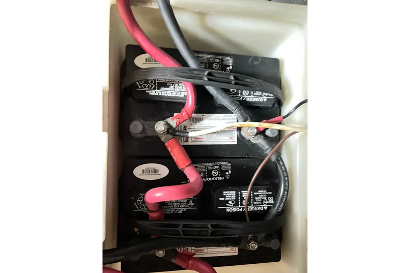 Slide: The Image of Battery compartment of a 1996 Riviera 4800 Sport Yacht with connected cables. - 65