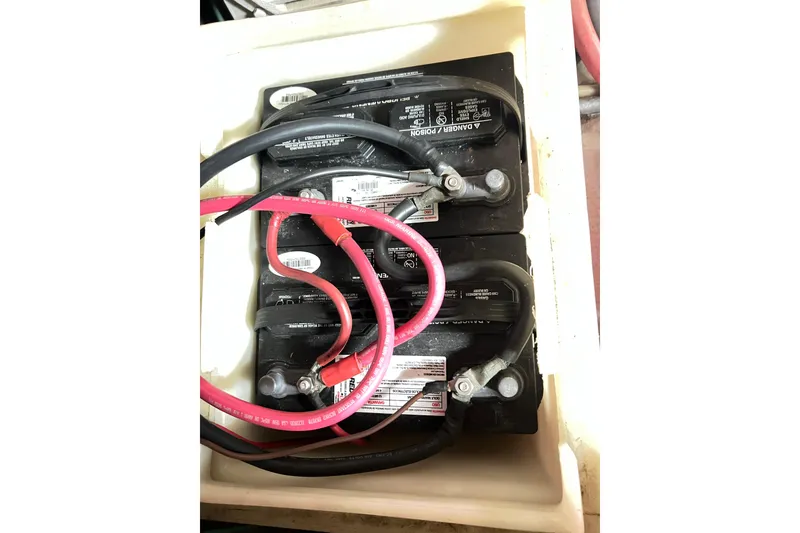 Slide: The Image of Battery setup in a 1996 Riviera 4800 Sport Yacht with red and black cables. - 68
