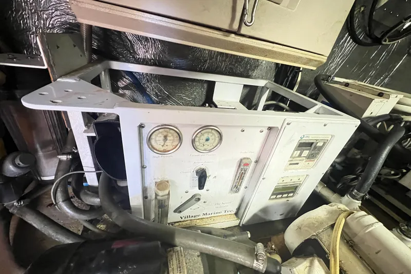 Slide: The Image of Engine room of 1996 Riviera 4800 Sport Yacht with gauges and control panel. - 69