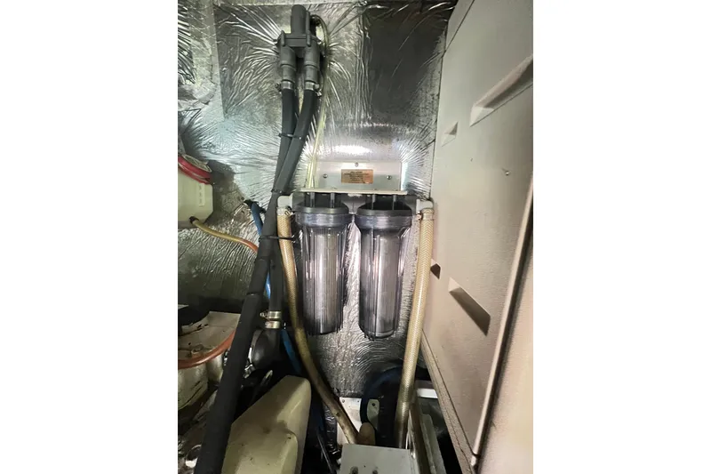 Slide: The Image of Engine room of 1996 Riviera 4800 Sport Yacht with dual water filters. - 70