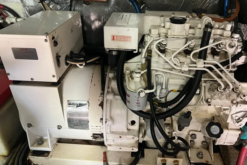 Slide: The Image of Engine room of a 1996 Riviera 4800 Sport Yacht, showcasing mechanical components. - 71