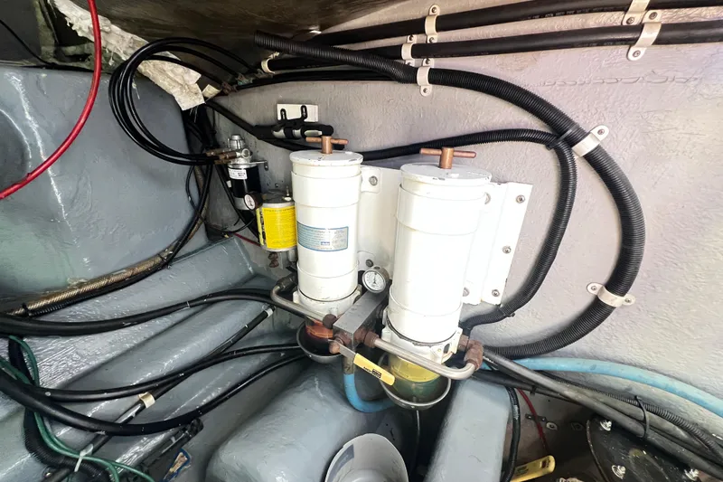 Slide: The Image of Engine compartment of 1996 Riviera 4800 Sport Yacht with fuel filters and wiring. - 72