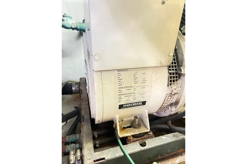 Slide: The Image of Engine compartment of a 1996 Riviera 4800 Sport Yacht, featuring a generator unit. - 76