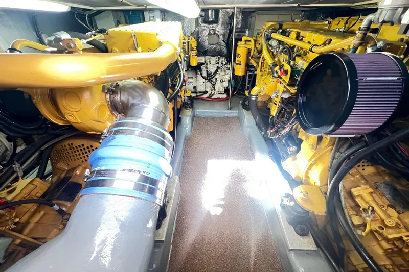 Slide: The Image of Engine room of a 1996 Riviera 4800 Sport Yacht with visible machinery and components. - 79