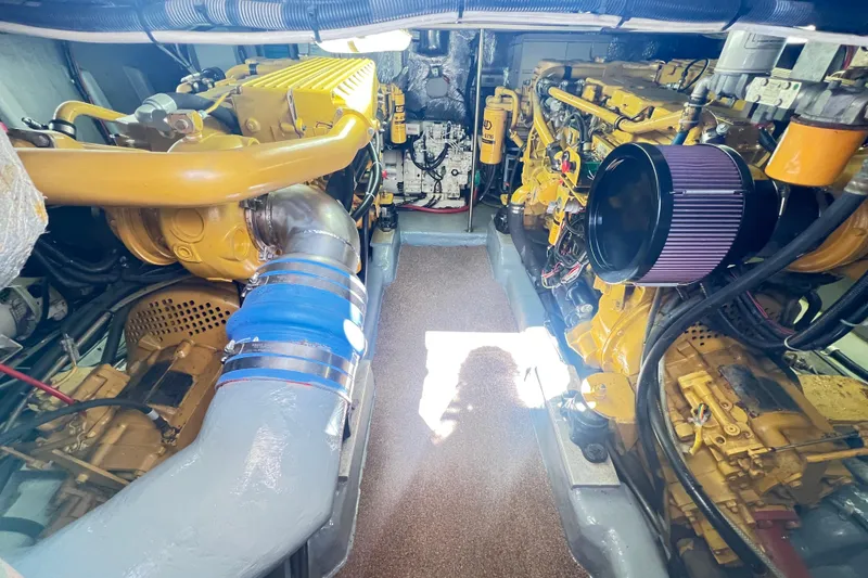 Slide: The Image of Engine room of a 1996 Riviera 4800 Sport Yacht, showcasing dual yellow engines. - 80