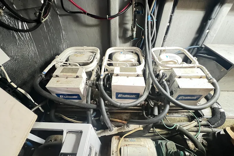 Slide: The Image of Engine room of 1996 Riviera 4800 Sport Yacht with Cruisair units and wiring. - 82