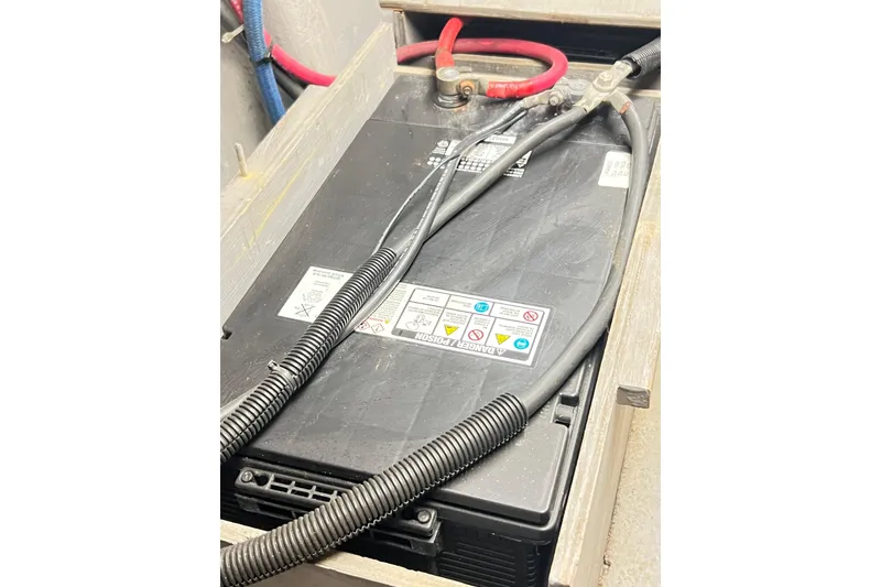 Slide: The Image of Battery compartment of a 1996 Riviera 4800 Sport Yacht with connected cables. - 85