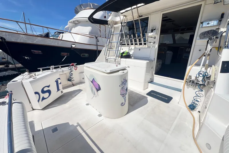 Slide: The Image of Riviera 4800 Sport Yacht 1996 deck with nautical decor and marina view. - 87