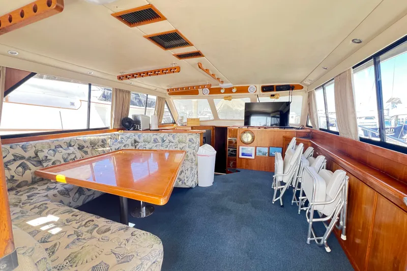 Slide: The Image of Interior of 1996 Riviera 4800 Sport Yacht with spacious seating and elegant wood finishes. - 92
