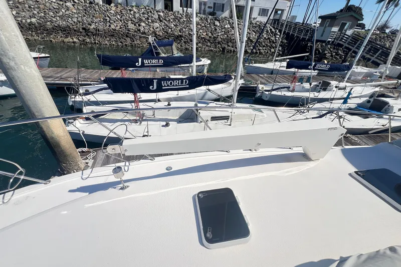 Slide: The Image of Riviera 4800 Sport Yacht 1996 docked, surrounded by smaller sailboats in a marina. - 94