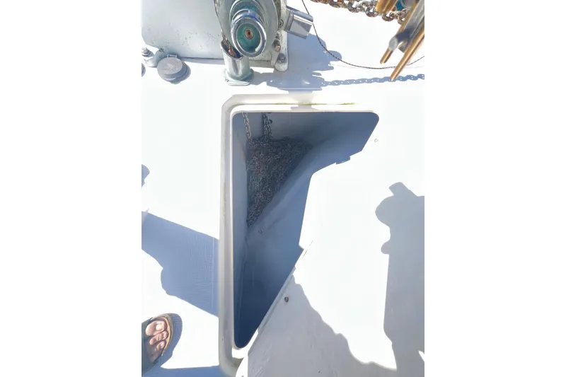 Slide: The Image of Anchor chain compartment on 1996 Riviera 4800 Sport Yacht deck, with visible winch mechanism. - 97