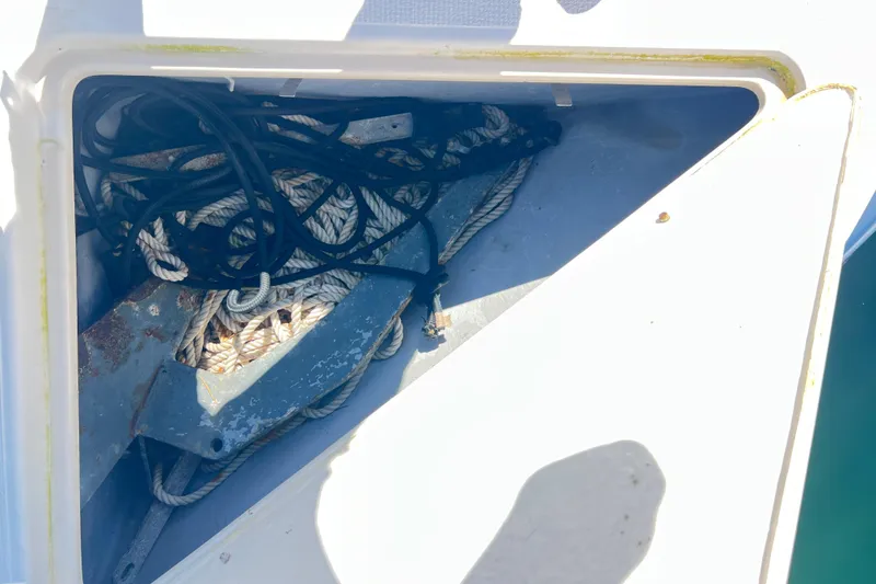 Slide: The Image of Anchor and ropes stored in a compartment of a 1996 Riviera 4800 Sport Yacht. - 99