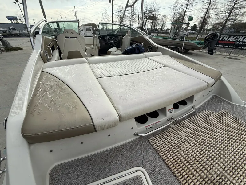 Slide: The Image of 2007 Sea Ray 210 boat with cushioned deck and helm. - 14