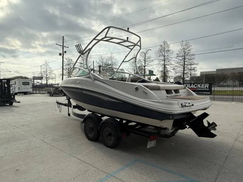 Slide: The Image of 2007 Sea Ray 210 boat on trailer under cloudy sky. - 4